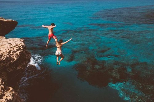 Two People Diving From The Cliff
